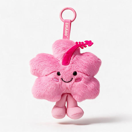 Hibi, personnage hibiscus rose signature EMANO avec pétales doux et sourire brodé