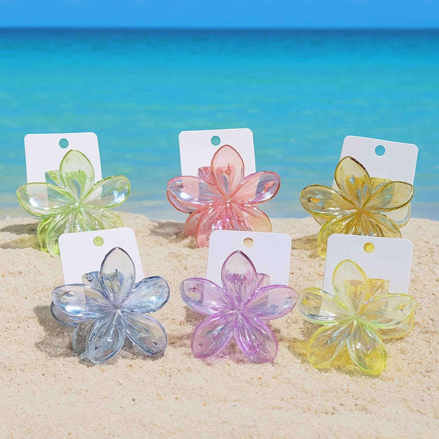 Pinces à cheveux en forme de fleur, couleurs pastel iridescentes, accessoires tendance disponibles chez Emano Nouvelle-Calédonie.